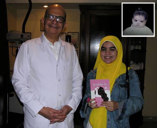 young writer Merna presents her new book to Dr Ahmad Khalil who did her congenital glaucoma operation shortly after her birth